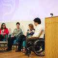 Four people talking on a stage in a panel discussion