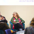 Speakers on a panel discussion during a conference