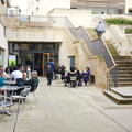 An outdoor view of conference attendees networking at Pembroke College, Oxford