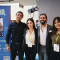 A startup team posing for a photo at their stand