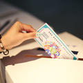 A hand posting a fake #StartedinOxford Showcase 2025 note into a voting box