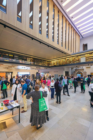 A large hall full of people at a showcase event
