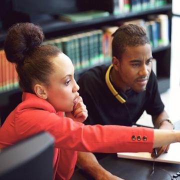 Two students concentrating and working together